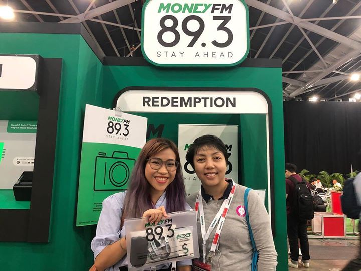 Two ladies posing for a picture with their gift after completing the MoneyFM Interactive ATM Trivia Game
