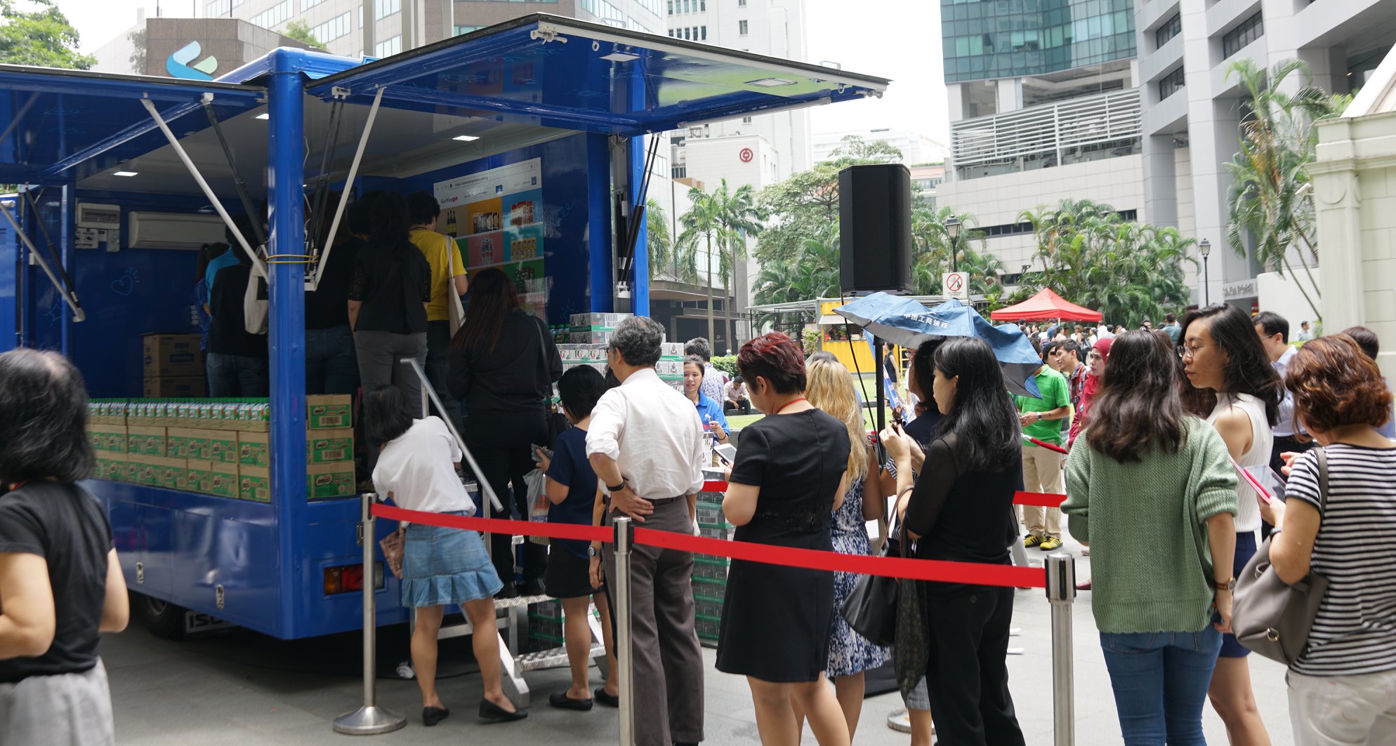 People queueing for their turn at the fairprice on interactive tap and win kiosk
