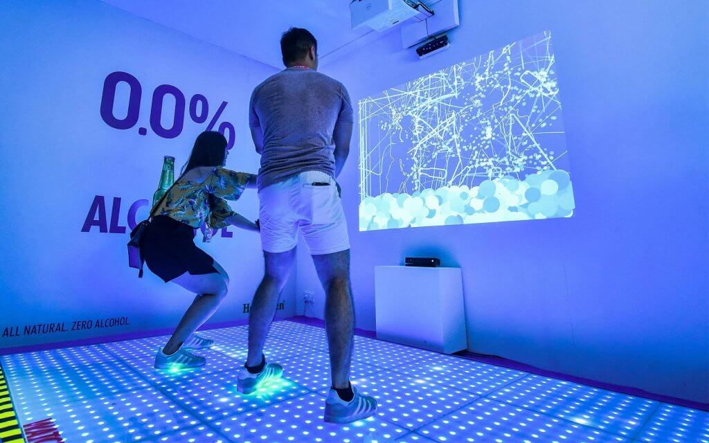 A couple participating in the Heineken 0.0 Interactive Dance Studio