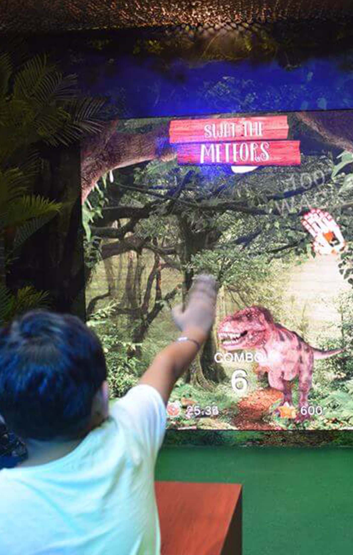 A little boy plays the Ultimate Rex Gesture Game