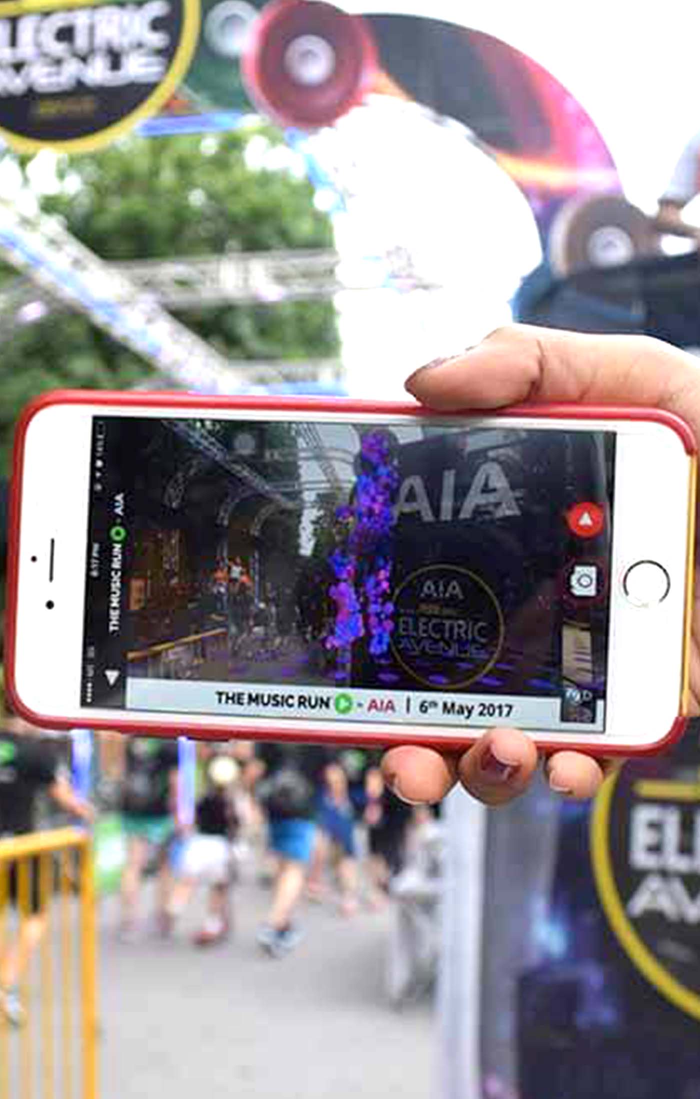 A woman using the AIA The Music Run Smart Filter App at the event itself.