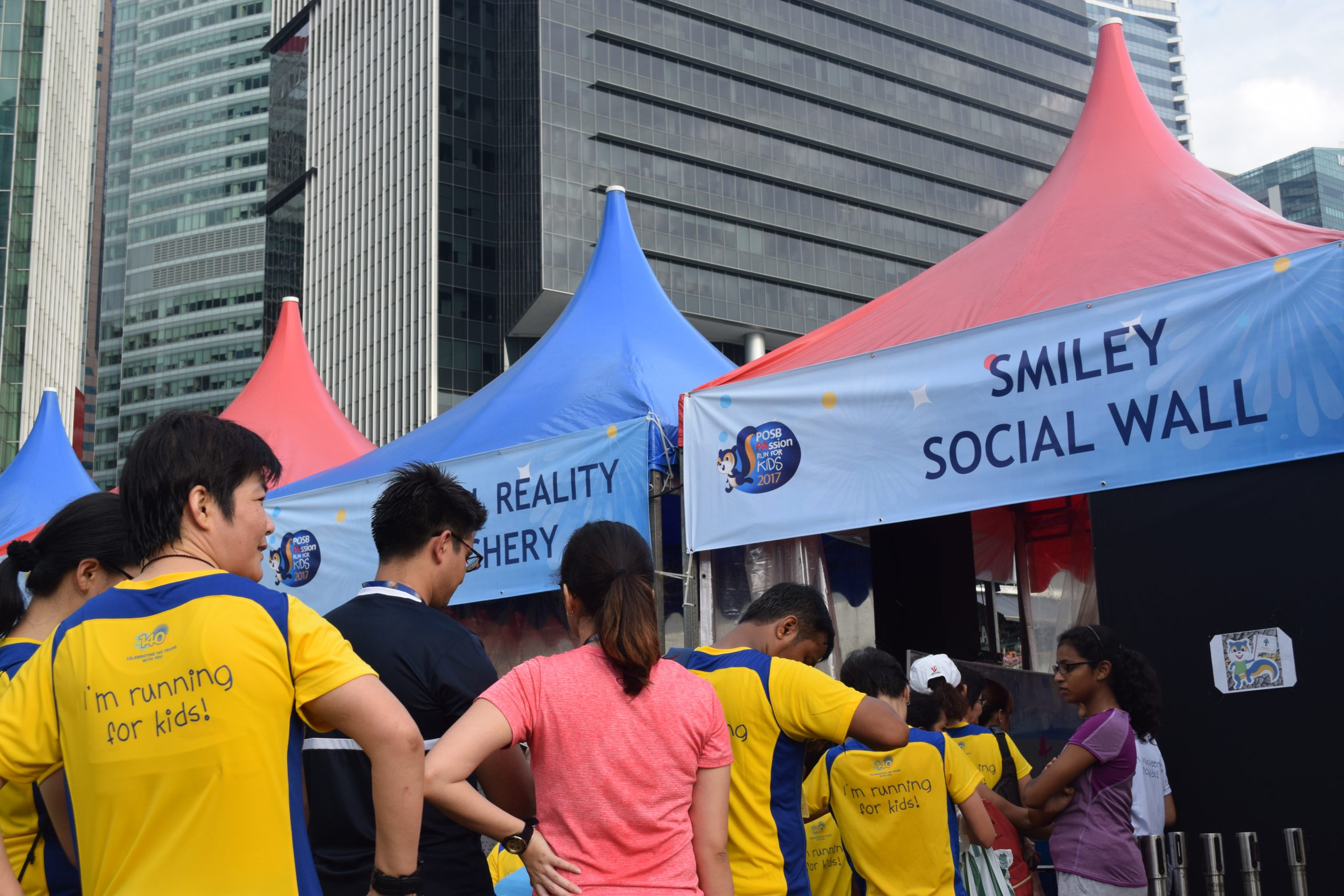 A group of runners queuing for POSB Passion Run for Kids AR Photobooth post-running