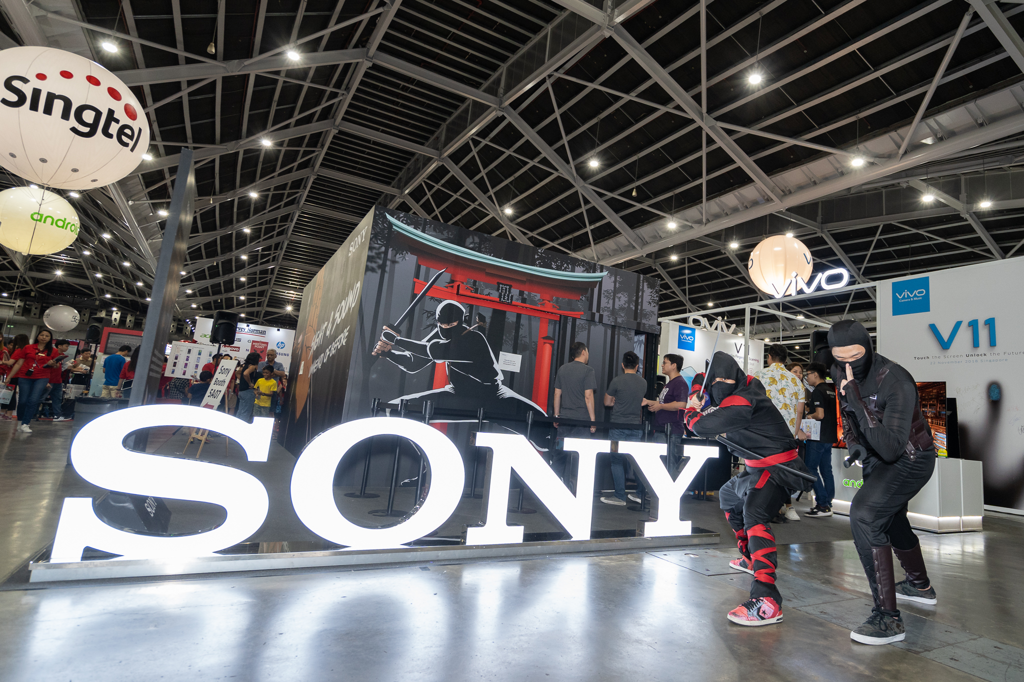 Two ninja cosplayers posing in front of the Sony Bravia OLED Experience Popup Event