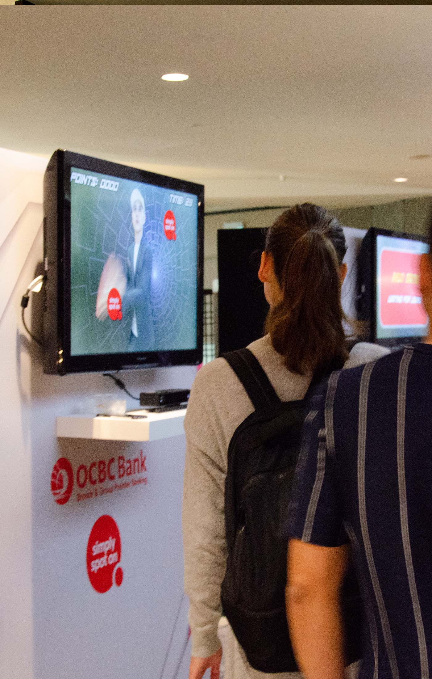 People queuing to interact with OCBC Quick Reaction Game Kiosk