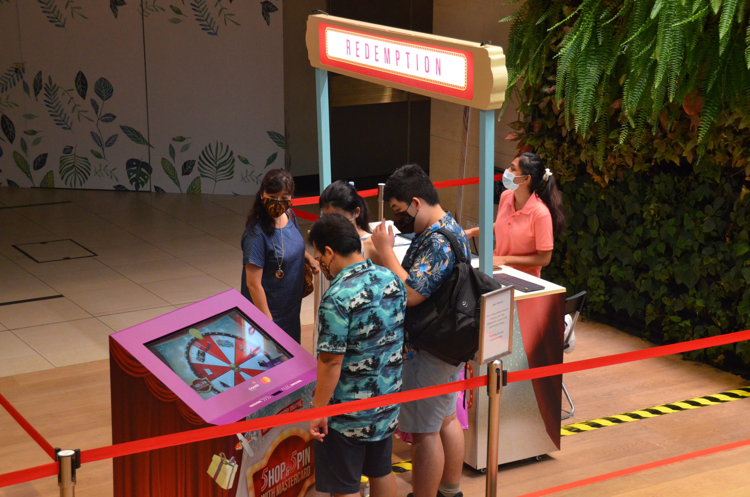 People queueing for the Contactless shop and spin grand lucky draw system at changi airport
