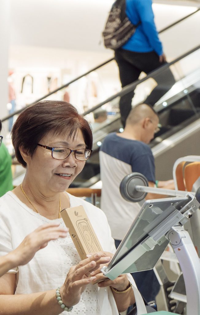 Elderly woman plays the CPF Swipe Away The Fake News educational quiz game on a tablet
